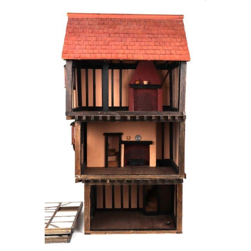 125 - A three storey Tudor style doll's house based on a National Trust owned timber framed and jettied ho... 