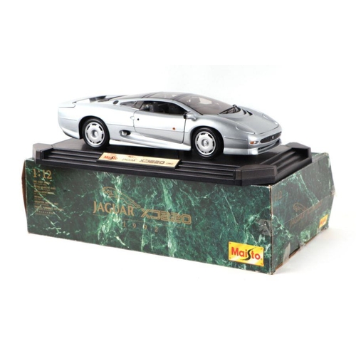 192 - A Maisto 1/12 scale Jaguar XJ220 diecast car mounted on a plinth, boxed.