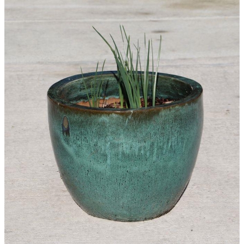 24 - A large green glazed terracotta pot, 45cms diameter.