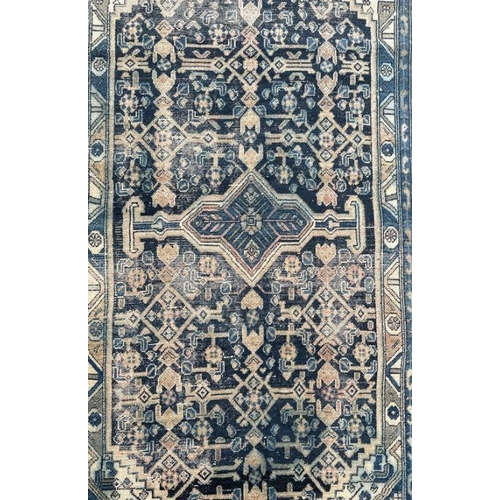 269 - A Persian rug with central medallion on a blue ground, within a multi border, 233 by 132cms.