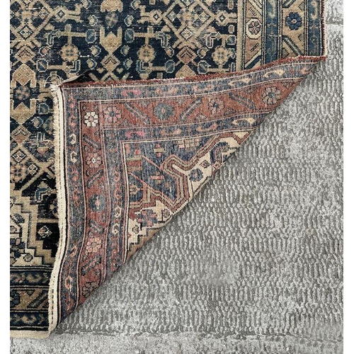 269 - A Persian rug with central medallion on a blue ground, within a multi border, 233 by 132cms.