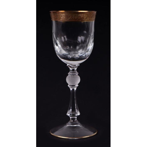 424 - Nine St Louis style wine glasses with gilded rims and faceted bowls, 20cms high.