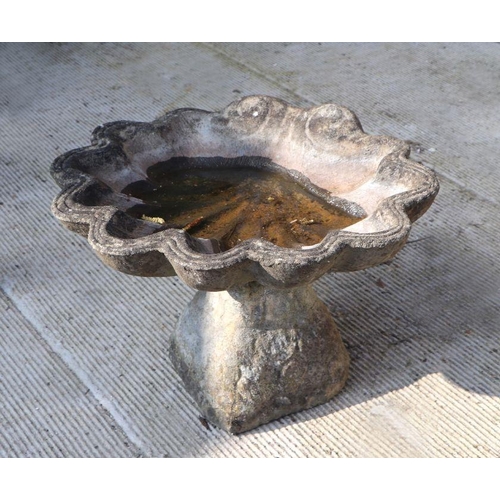 5 - A reconstituted stone shell shaped bird bath, 55cms wide.