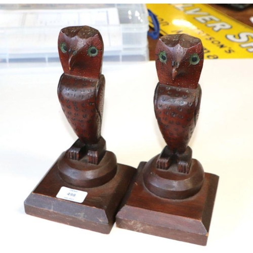 527 - A pair of naïve folk art carved wooden owls, 25cms high.