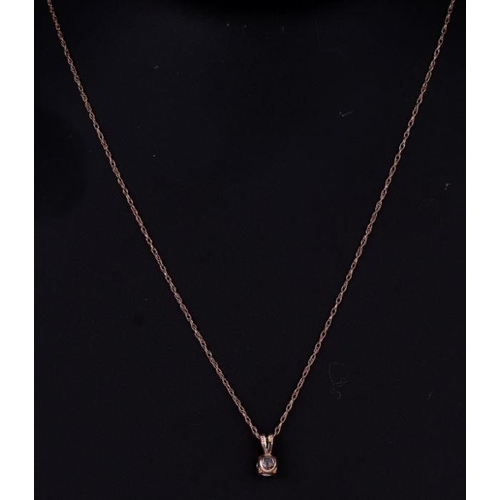 654 - A 15ct gold mounted cubic zirconia pendant on a fine gold chain, 1.4g.