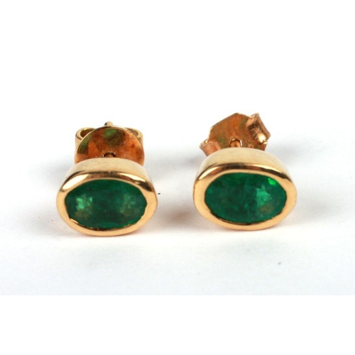 655 - A pair of 18ct gold emerald set stud earrings.