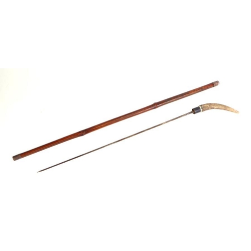 76 - A cane shafted sword stick with a stag horn handle and having a 56cms (22ins) square section blade, ... 