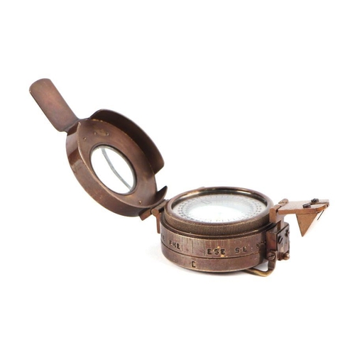 85 - A WWII style military field compass; together with assorted military cap badges.