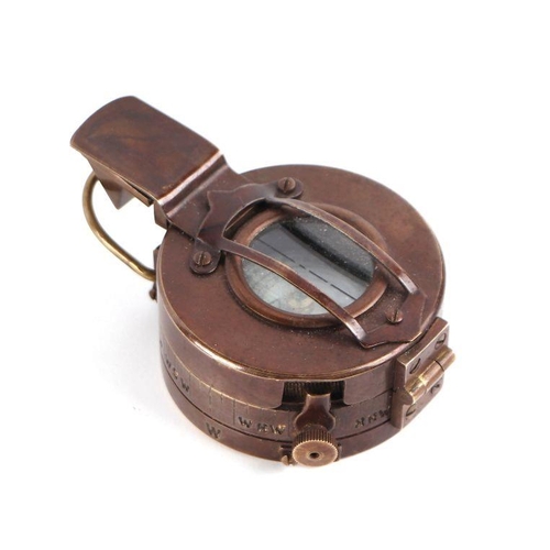 85 - A WWII style military field compass; together with assorted military cap badges.