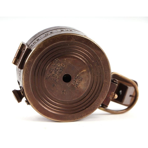 85 - A WWII style military field compass; together with assorted military cap badges.