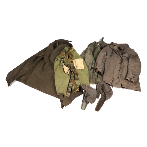 89 - A quantity of assorted military uniform to include winter jackets and other similar items.