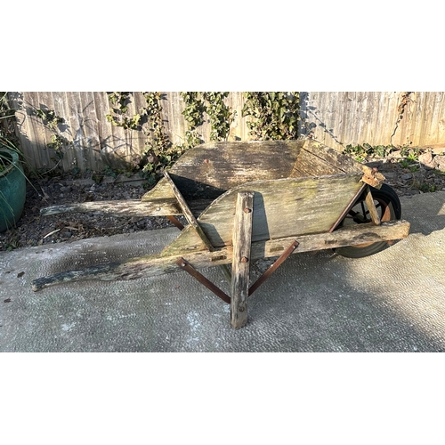 29 - A decorative wooden wheelbarrow, 56cms wide.