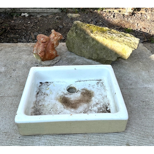 25 - A ceramic butler's sink, 62cms wide, a garden figure of a squirrel together with a large piece of Pu... 