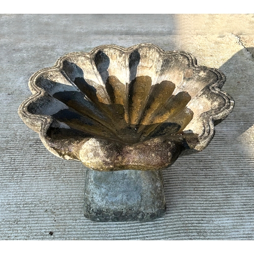 5 - A reconstituted stone shell shaped bird bath, 55cms wide.