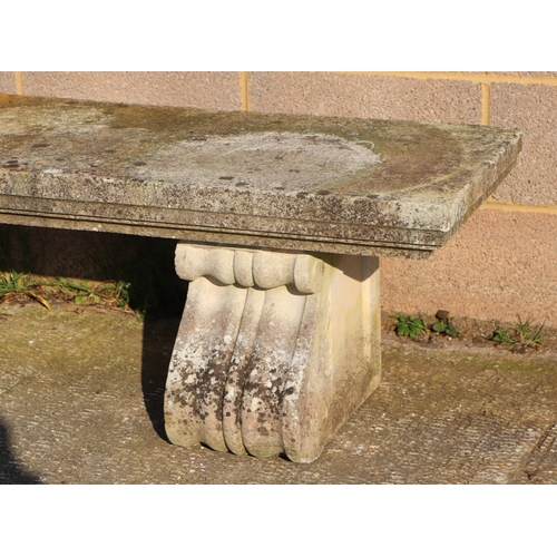 28 - A large and very heavy well weathered reconstituted stone bench on scroll supports, 168cms.