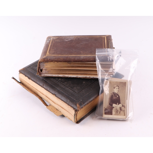 37 - Two Victorian leather photograph albums containing various Carte de Visite portraits and a selection... 