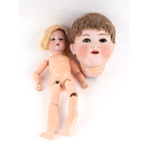 124A - A bisque head doll with composite body together with bisque dolls head.