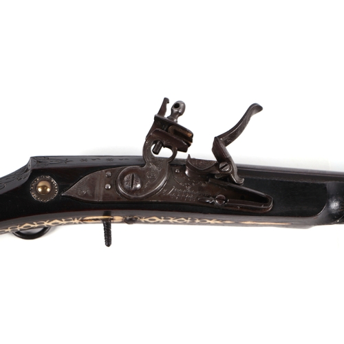 103 - A 19th century North African flintlock long gun, the lock and barrel signed and the stock with inlai... 