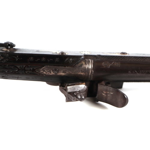 103 - A 19th century North African flintlock long gun, the lock and barrel signed and the stock with inlai... 