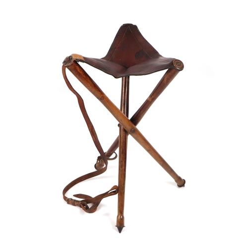 93 - A 19th century Military Campaign folding tripod stool with leather seat with impressed maker's mark ... 