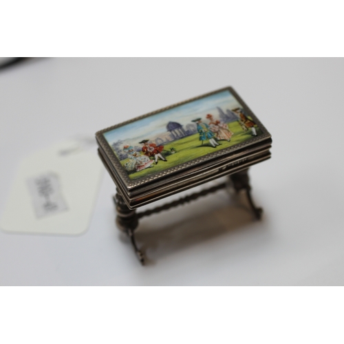 589 - An Edwardian miniature silver & enamel box modelled as an occasional table on turned supports joined... 