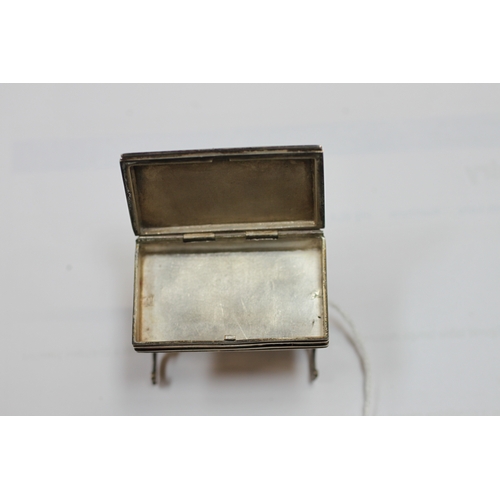 589 - An Edwardian miniature silver & enamel box modelled as an occasional table on turned supports joined... 