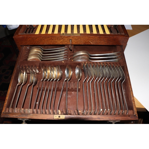 549 - An oak canteen containing Old English Pattern silver plated cutlery, 45cms diameter.