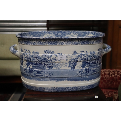 442 - A 19th century blue & white two-handled footbath decorated with flowers within urns, 54cms wide.