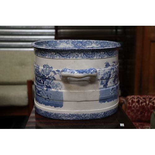 442 - A 19th century blue & white two-handled footbath decorated with flowers within urns, 54cms wide.