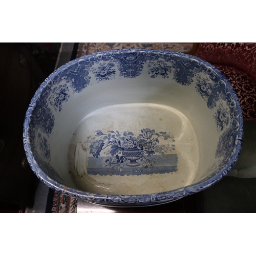 442 - A 19th century blue & white two-handled footbath decorated with flowers within urns, 54cms wide.