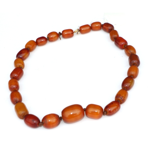 622 - A butterscotch amber type graduated bead necklace, 58cms long, 94g.