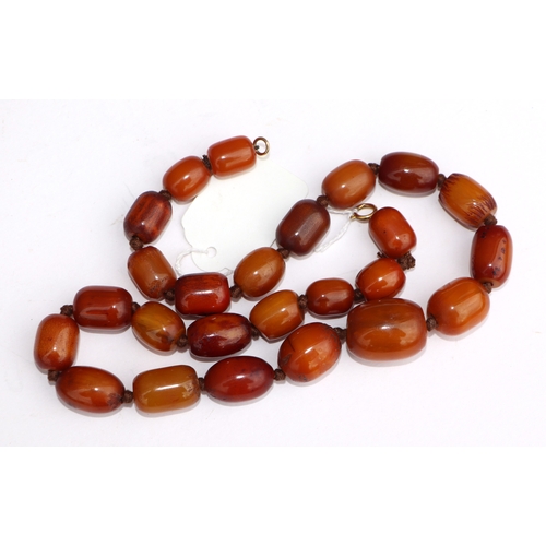 622 - A butterscotch amber type graduated bead necklace, 58cms long, 94g.