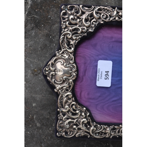 594 - An Edwardian silver strut photo frame, Birmingham 1905, overall 19.5 by 27cms.