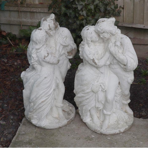 1 - A pair of reconstituted stone figural groups depicting courting couples, each approx 80cms high (2).