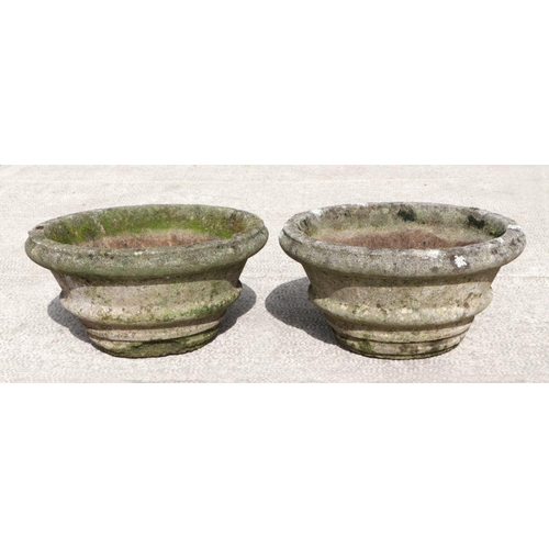 10 - A pair of well weathered reconstituted stone circular planters, each approx 60cms diameter (2).