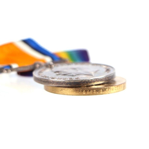 105 - A WWI medal pair named to 'Captain E. Fawcett; a WWII medal; a Newton College Challenge Cup medallio... 