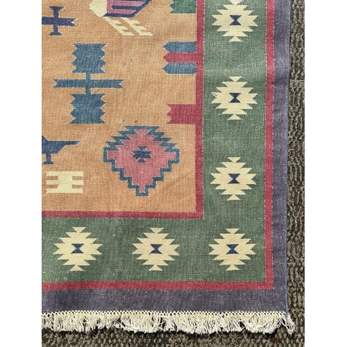 119 - An Indian dhurrie Kilim rug with central medallion on a camel ground with stylised birds and symbols... 