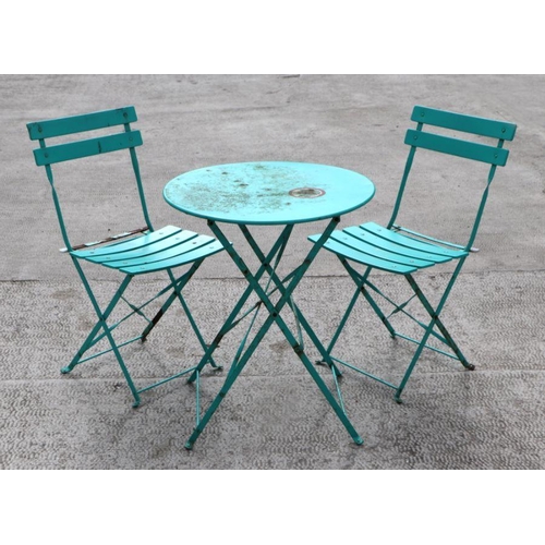 12 - A Bistro or patio garden set comprising circular folding table, 59cms diameter; and two matching sla... 