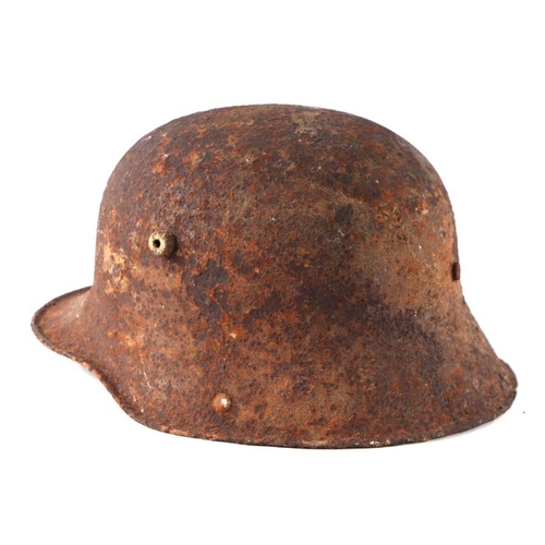 24 - A WWII German helmet (battlefield pick up condition).