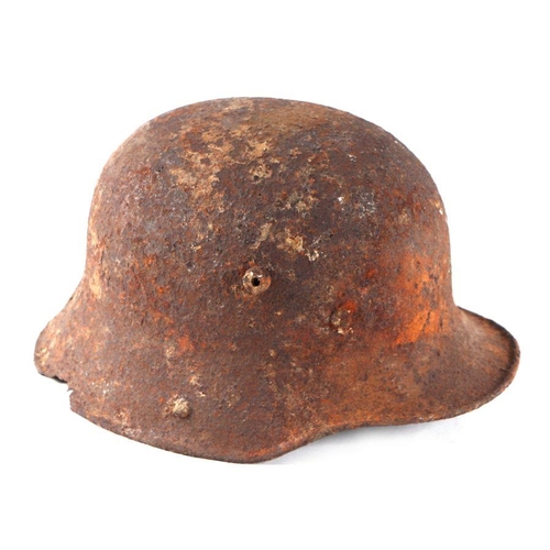 24 - A WWII German helmet (battlefield pick up condition).