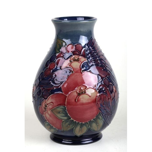 351 - A William Moorcroft Pomegranate, Grape & Birds pattern squat baluster form vase with tube lined deco... 