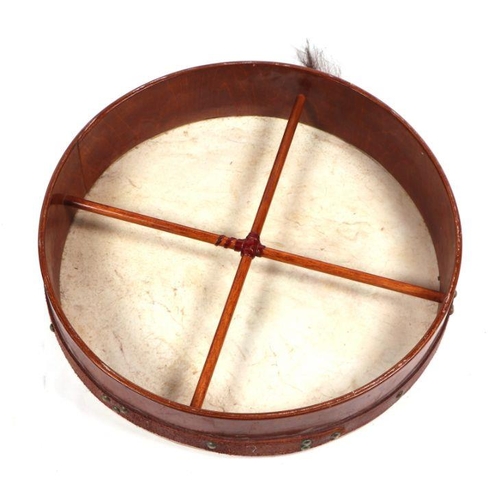 353 - An Irish Bodhran drum decorated with a Celtic design, 47cms diameter.