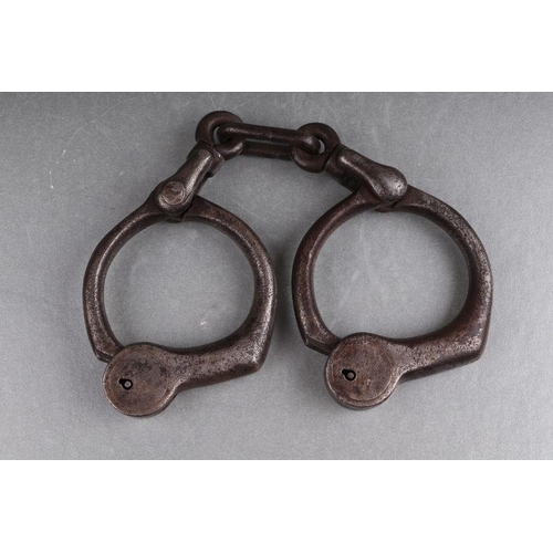 36 - A pair of steel handcuffs (lacks key).