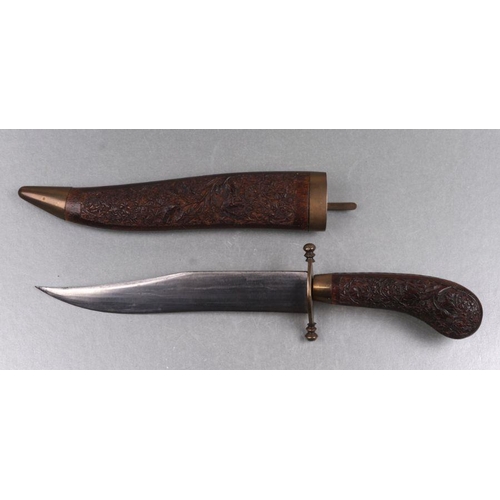 37 - An Indian dagger with carved hardwood scabbard and handle, 34cms long.