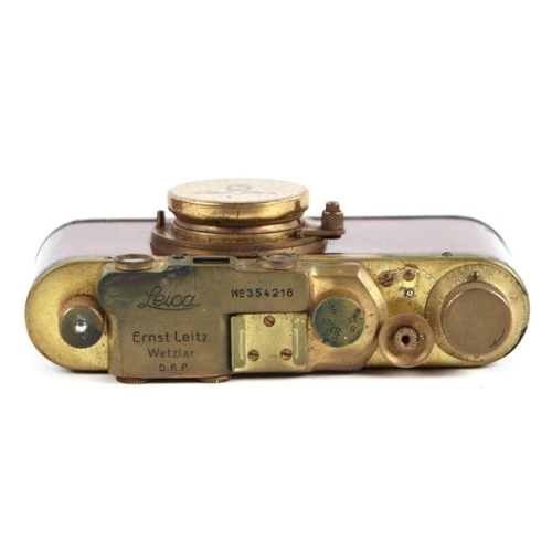 374 - A Leica M3 style brass camera in a leather case.