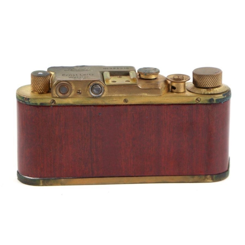 374 - A Leica M3 style brass camera in a leather case.