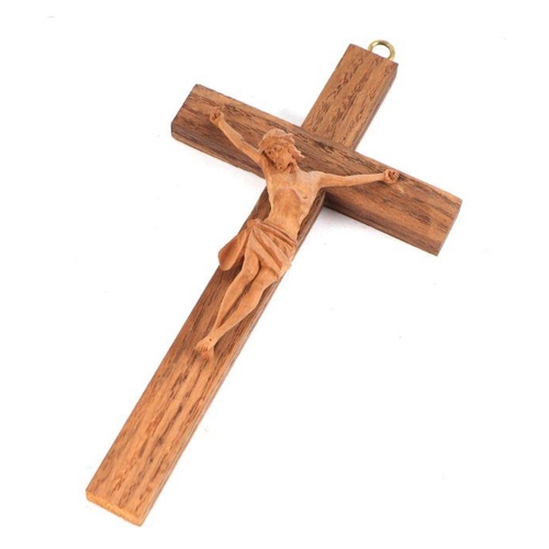 412 - A carved oak crucifix within an oak case, 26cms high.