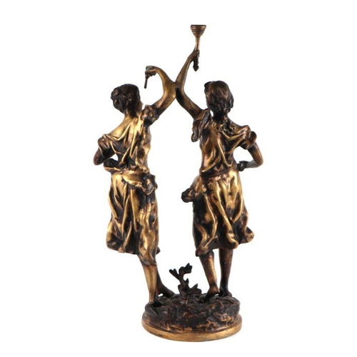 439 - After Moreau - a cast bronze figural group in the form of two hand maidens, one holding a torch alof... 