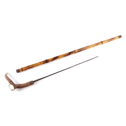 44 - A bamboo shafted sword stick with a stag horn handle and having a 49cms (19.25ins) square section bl... 