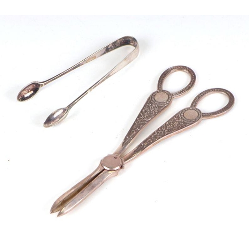 514 - A pair of Victorian style grape scissors, Sheffield 1930; and a pair of sugar tongs, 136g (2).